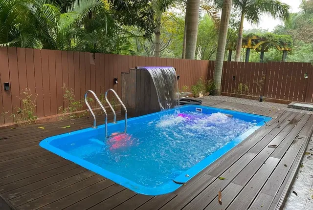 Fiberglass pool with deck and water feature